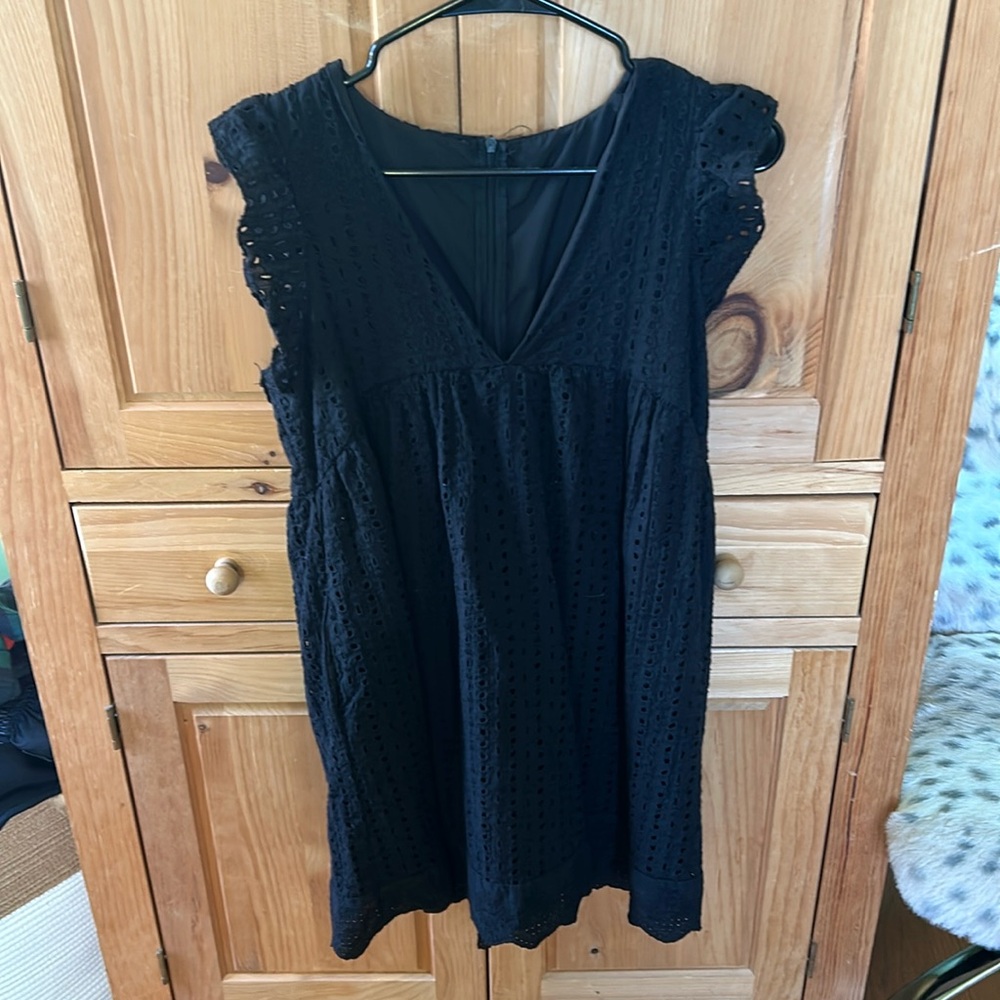 Black eyelet dress with shorts underneath and side pockets